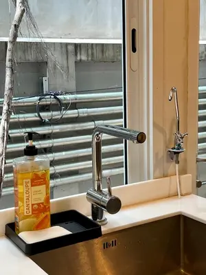 a kitchen sink with a faucet next to a window at Entire 3BR Townhome in Sukhumvit, shared Pool, near BTS&MRT Asok in Bangkok