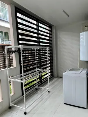 a room with a window with a table and a refrigerator at Entire 3BR Townhome in Sukhumvit, shared Pool, near BTS&MRT Asok in Bangkok