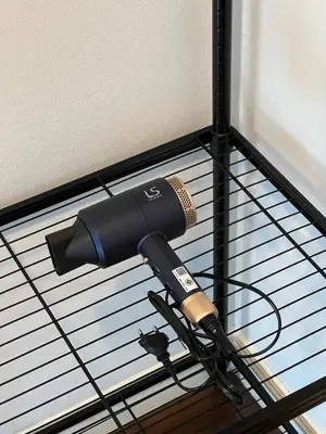 a blow dryer on top of a black rack at Entire 3BR Townhome in Sukhumvit, shared Pool, near BTS&MRT Asok in Bangkok