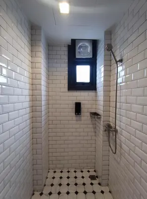 a bathroom with a shower with a window at N5 Ratchawong Hostel in Bangkok