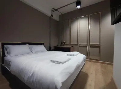 a bedroom with a large white bed with white pillows at N5 Ratchawong Hostel in Bangkok