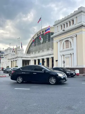 a black limousine parked in front of a building at Mr Black & Ms White -Self Check in accommodation in Pom Prap