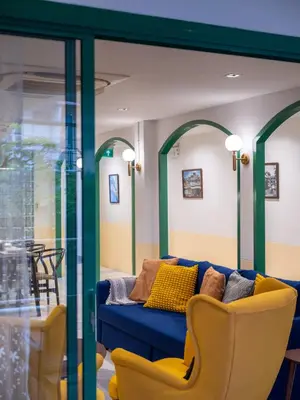 a living room with a blue couch and chairs at Bedtime storeys near ICON SIAM in Bangkok