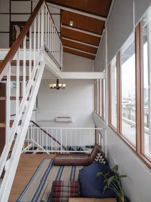 a living room with a staircase and a couch at Bedtime storeys near ICON SIAM in Bangkok