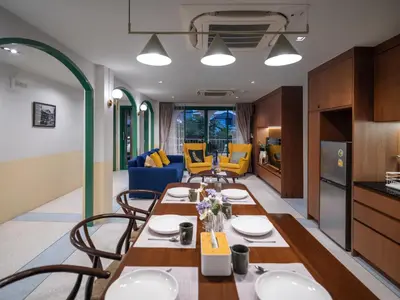 a kitchen and living room with a table and chairs at Bedtime storeys near ICON SIAM in Bangkok