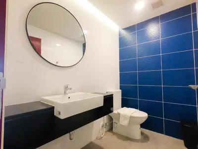 a bathroom with a sink and a mirror and a toilet at Bedtime storeys near ICON SIAM in Bangkok