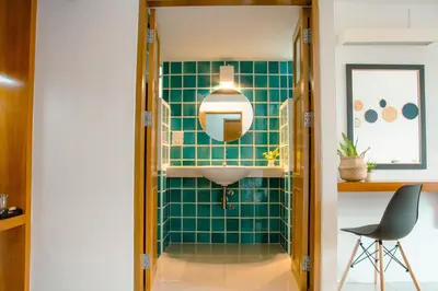 a bathroom with a sink and a mirror at Alley & Pier in Bangkok