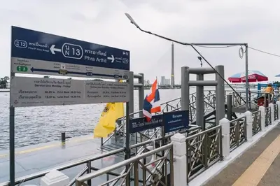 a sign on a pier next to a body of water at Alley & Pier in Bangkok