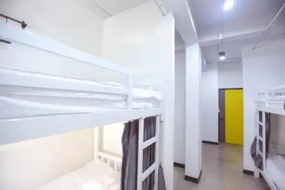 a room with two bunk beds and a hallway at G5 Hostel in Bangkok