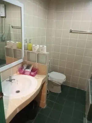 a bathroom with a sink and a toilet and a mirror at Baan Sood Soi Residence 1 บ้านสุดซอย เรซิเด้นท์ 1 in Ban Bang Bamru