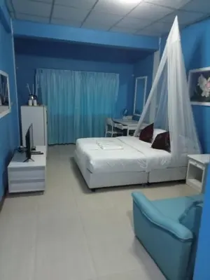 a bedroom with a bed and a table and a chair at Baan Sood Soi Residence 1 บ้านสุดซอย เรซิเด้นท์ 1 in Ban Bang Bamru
