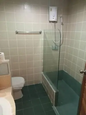 a bathroom with a shower with a toilet and a sink at Baan Sood Soi Residence 1 บ้านสุดซอย เรซิเด้นท์ 1 in Ban Bang Bamru