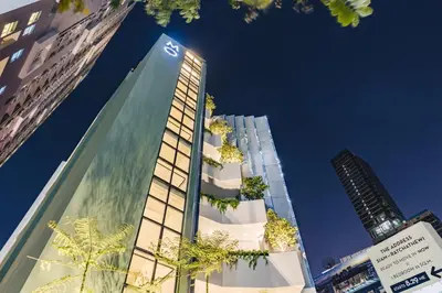 a tall building with plants on the side of it at MO Hotel Bangkok in Bangkok