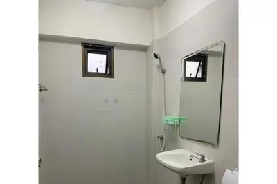 a white bathroom with a sink and a mirror at OYO 75577 Palace Hostel in Amphoe Phra Khanong