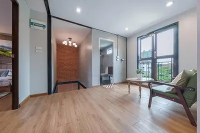 a living room with a couch and a table at Thananya Apartment in Amphoe Phra Khanong