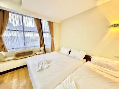 a hotel room with two beds and a window at ABC SO Hotel Bangkok in Bangkok