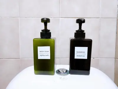 two bottles of soap sitting on top of a sink at 814-STP Homely room Free Wi-Fi and Near BTS line in Bangkok