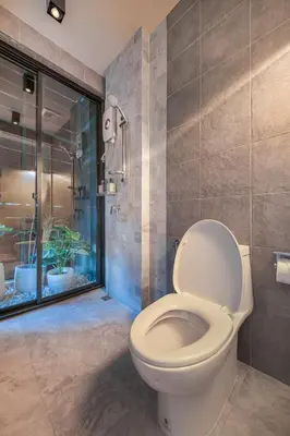 a bathroom with a toilet and a shower at Siam Shelter Bangkok in Bangkok