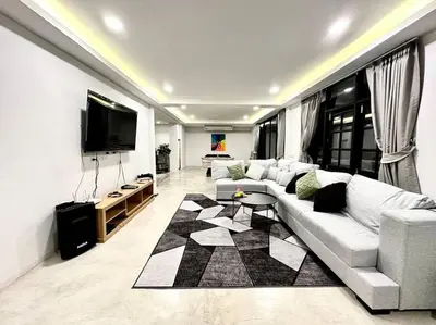 a living room with a white couch and a flat screen tv at Number3 Poolvilla Bangkok in Lat Krabang