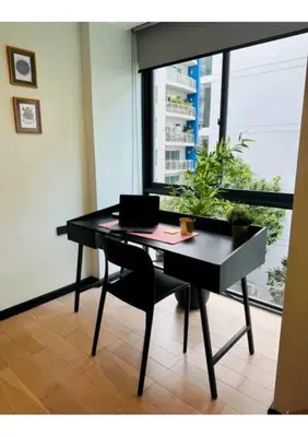 a desk with a laptop and a chair in a room at Serene home in the heart of BKK - The Great Wave in Bangkok