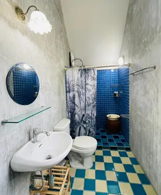 a bathroom with a sink and a toilet and a shower at The Backyard 28 in Khlong Toei