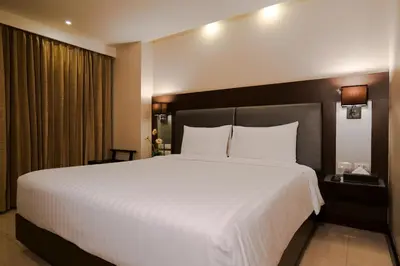 a large white bed in a hotel room at The Prestige Nana in Bangkok
