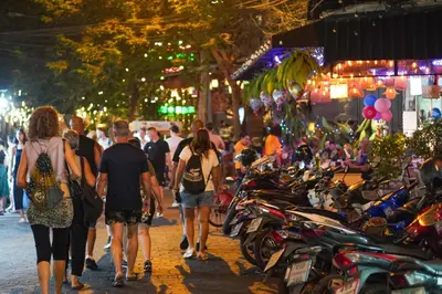 a group of people walking down a street with motorcycles at Tinidee Trendy Bangkok Khaosan in Bangkok