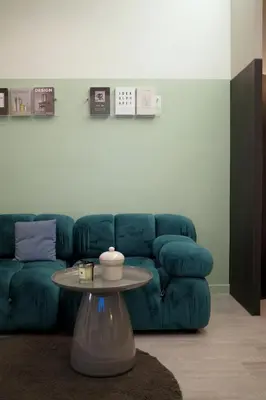 a living room with a blue couch and a table at Theme Stories - Boutique Guesthouse in Bangkok