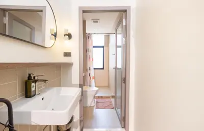 a bathroom with a sink and a toilet at Theme Stories - Boutique Guesthouse in Bangkok