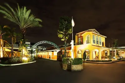 a yellow house with a palm tree in front of it at เดอะวิลล่า71 รีสอร์ท in Ban Zong Katiam