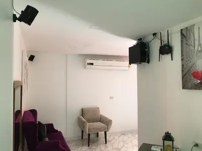 a living room with two chairs and a tv at เดอะวิลล่า71 รีสอร์ท in Ban Zong Katiam