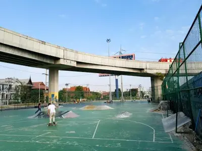 a person riding a skateboard in a skate park under a bridge at The Loftel Resort in Bangkok