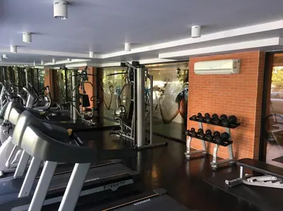 a gym with lots of treadmills and machines at Marigold Ramkhamhaeng in Bangkok