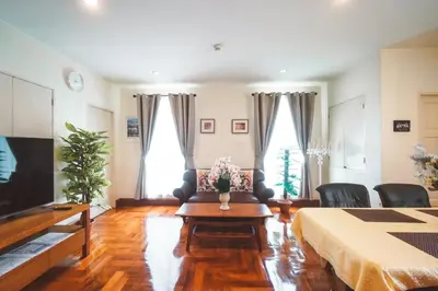 a living room with a couch and a table at Chez Moi Bangkok Private Executive Residence Sukhumvit 26 in Khlong Toei