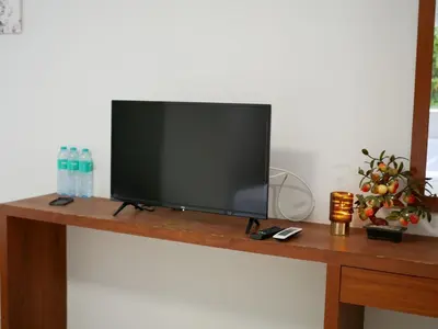 a flat screen tv sitting on top of a wooden table at ศิวพฤกษ์ เพลส in Nonthaburi
