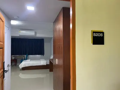 a bedroom with a bed and a sign on the wall at ศิวพฤกษ์ เพลส in Nonthaburi