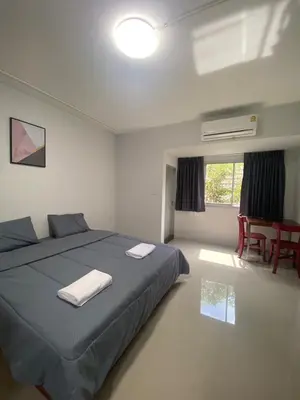 a bedroom with a bed and a table and chairs at ศิวพฤกษ์ เพลส in Nonthaburi