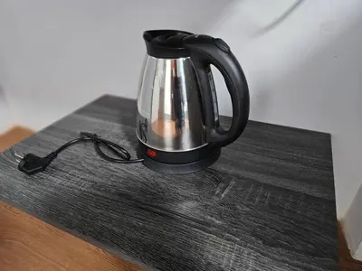 a black and silver tea kettle sitting on a table at Hommie by De-A-Ga in Ban Bang Talat