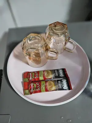 a white plate with two glasses and a candy bar at Hommie by De-A-Ga in Ban Bang Talat
