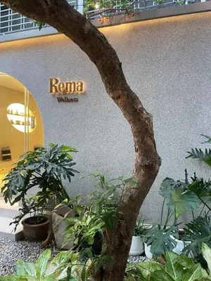 a tree in front of a building with plants at Rema residence China town Main Road in Bangkok