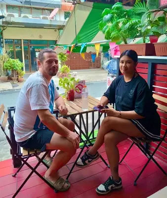 a man and a woman sitting at a table at 829 Backpack Bangkok BM B&B in Bangkok