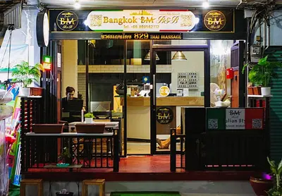 a restaurant with a person sitting at a table at Travel Bangkok BM B&B in Bangkok