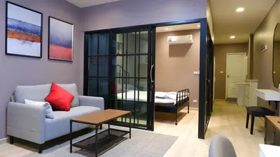 a living room with a couch and a table at BEB Silom Condolette in Bangkok