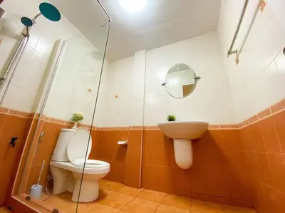 a bathroom with a toilet and a sink at Huge Living Room + 5 bedrooms with Private baths in Bangkok