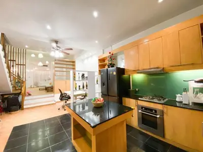 a kitchen with a black counter top in a room at Huge Living Room + 5 bedrooms with Private baths in Bangkok