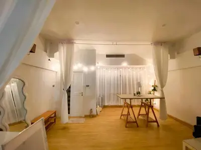 a living room with a table and a room with a table at Huge Living Room + 5 bedrooms with Private baths in Bangkok