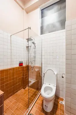 a bathroom with a toilet and a shower at Cozy Room at The Coffee Store Charoenkrung in Bangkok