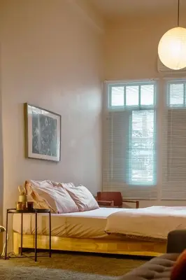 a bedroom with two beds and two windows at Cozy Room at The Coffee Store Charoenkrung in Bangkok
