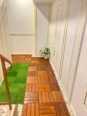 a hallway with wooden floors and a green rug at Guesthouse Station in Bangkok