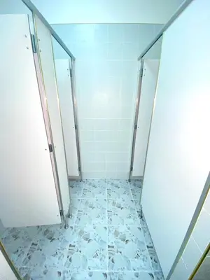 a bathroom with two stalls and a tiled floor at Guesthouse Station in Bangkok